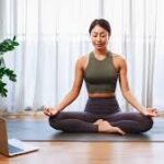 person practicing mindfulness yoga with breathwork in a peaceful outdoor setting