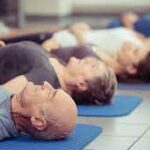 person using props in restorative yoga pose to calm the body for sleep