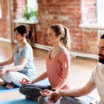 employee doing seated yoga and breath awareness at workstation