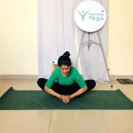 Text: Pregnant woman practicing prenatal yoga at home in Noida